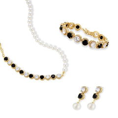 Gold-plated jewelry set with alternating black and clear cubic zirconia stones, featuring necklace, earrings and bracelet