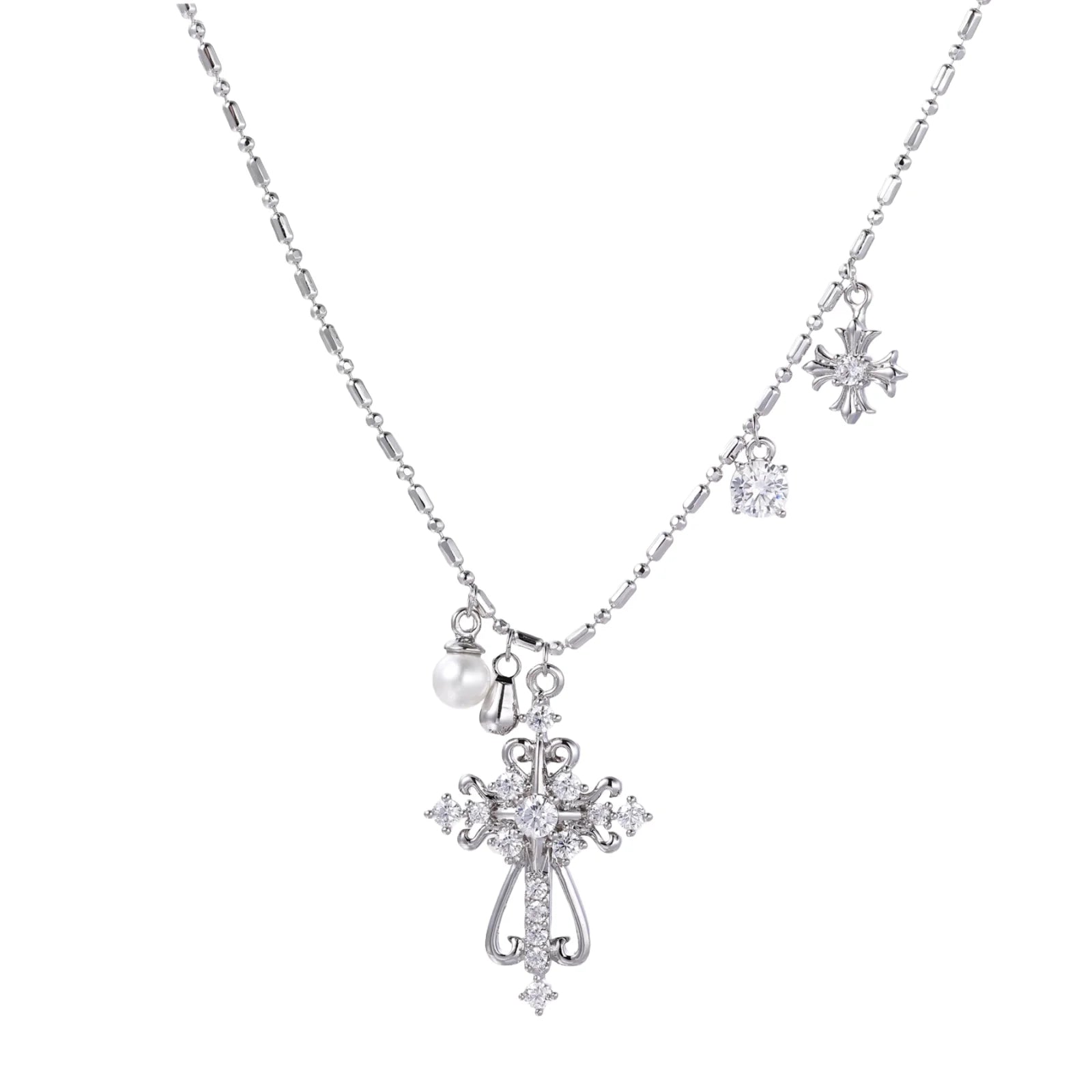 Ornate white gold-plated cross pendant with zirconia stones and pearl accents on adjustable silver chain against cream background